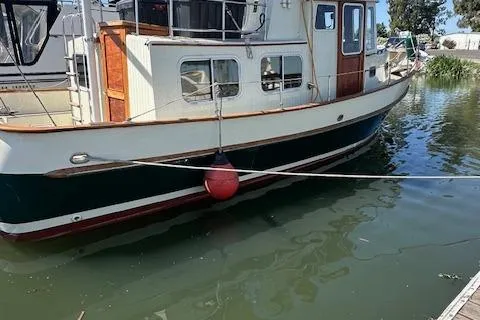 Slide: The Image of 1985 Eagle Trawler boat docked on calm water with red buoy. - 17