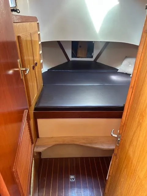 Slide: The Image of Cozy cabin interior of 1985 Eagle Trawler with wooden finishes and cushioned bed. - 4