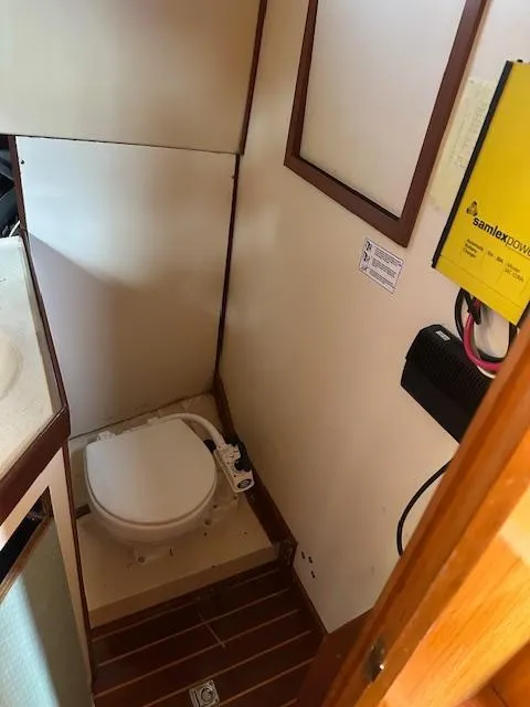 Slide: The Image of 1985 Eagle Trawler bathroom with toilet and Samlex power converter. - 5