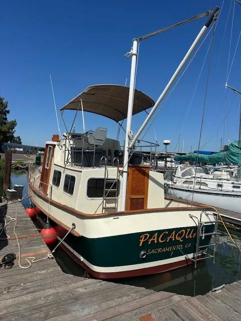 Slide: The Image of 1985 Ankertrawler Trawler docked at marina under clear blue sky. - 1