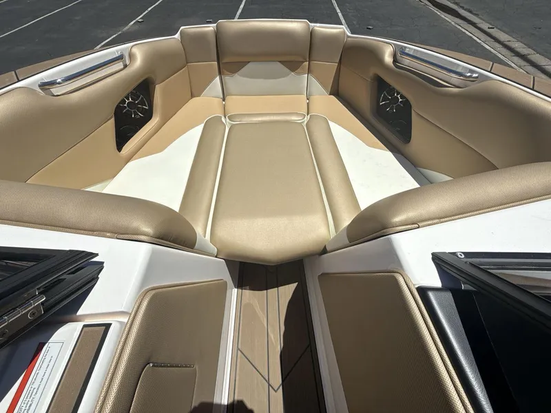 Slide: The Image of 2021 Moomba Mojo boat interior with tan seating and speaker system. - 11