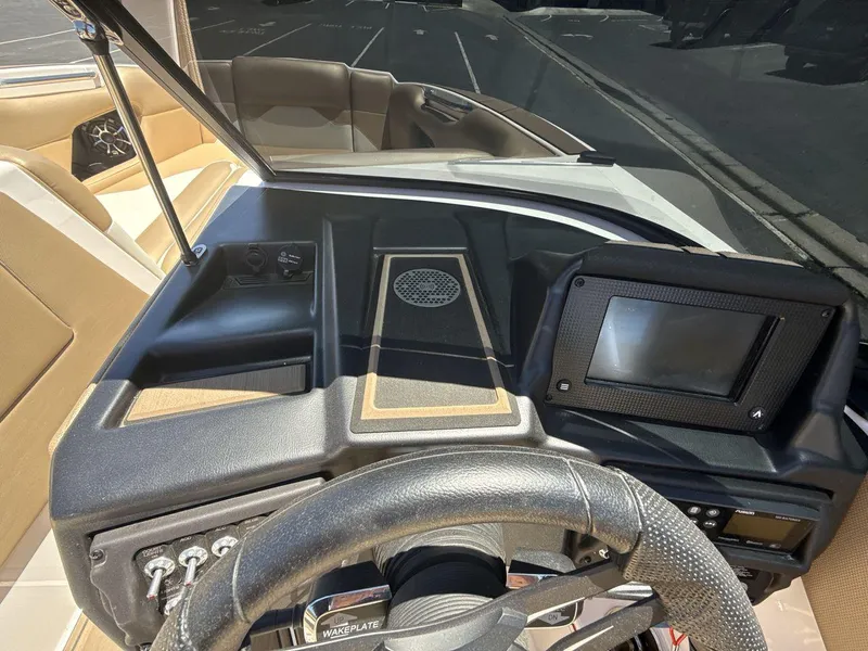 Slide: The Image of 2021 Moomba Mojo boat dashboard with steering wheel and control panel. - 15