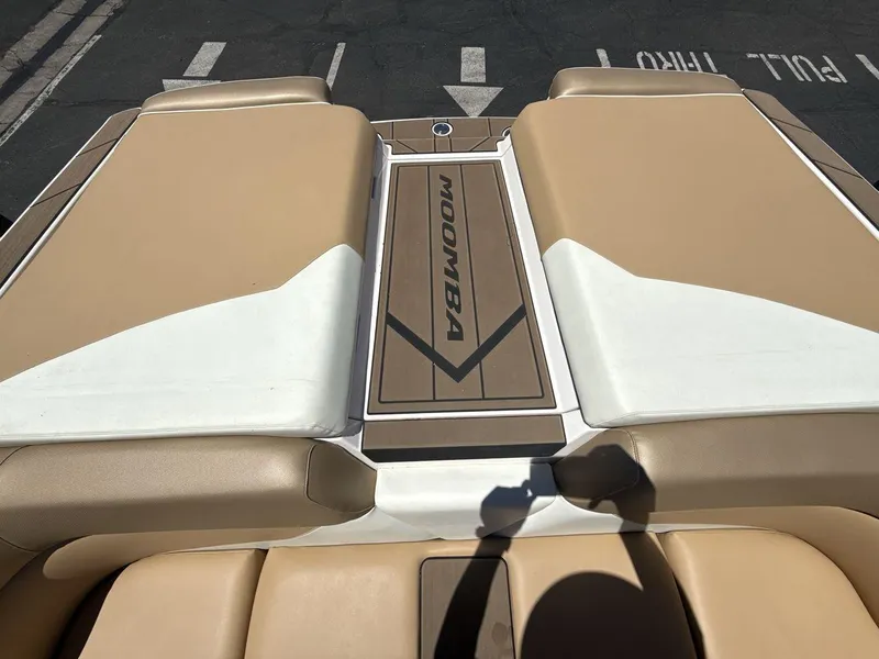 Slide: The Image of 2021 Moomba Mojo boat interior with tan and white seating. - 19