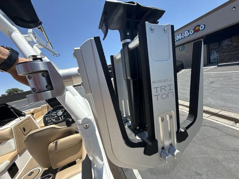 Slide: The Image of 2021 Moomba Mojo boat with Roswell Triton wakeboard rack in a parking lot. - 22