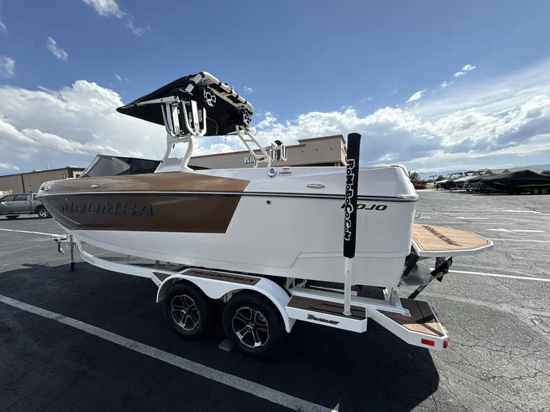 Slide: The Image of 2021 Moomba Mojo boat on trailer under a clear blue sky. - 3