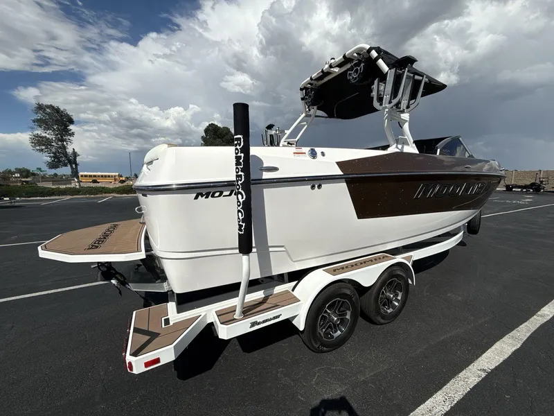Slide: The Image of 2021 Moomba Mojo boat on trailer under cloudy sky. - 5