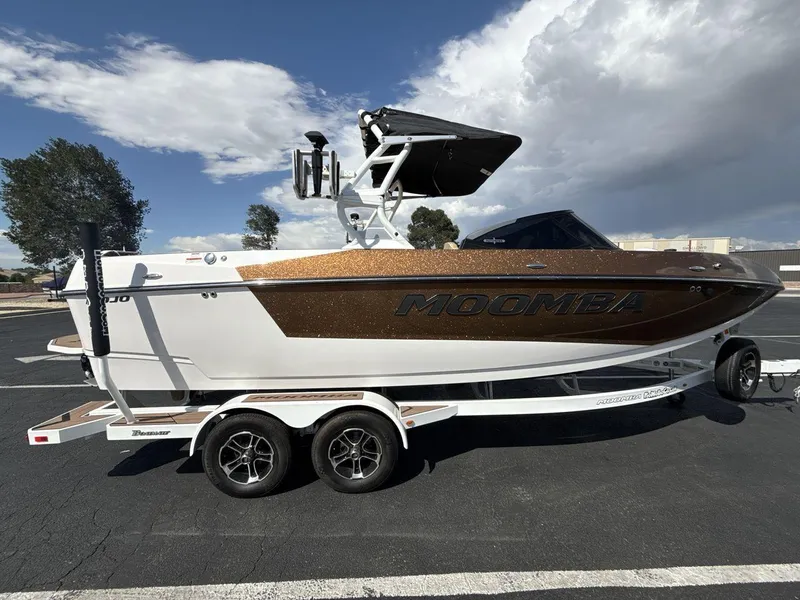 Slide: The Image of 2021 Moomba Mojo boat on trailer under a partly cloudy sky. - 6