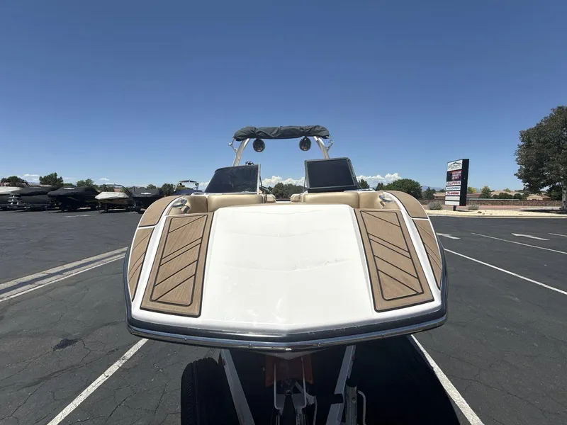 Slide: The Image of 2021 Moomba Mojo boat in parking lot, front view under clear blue sky. - 8