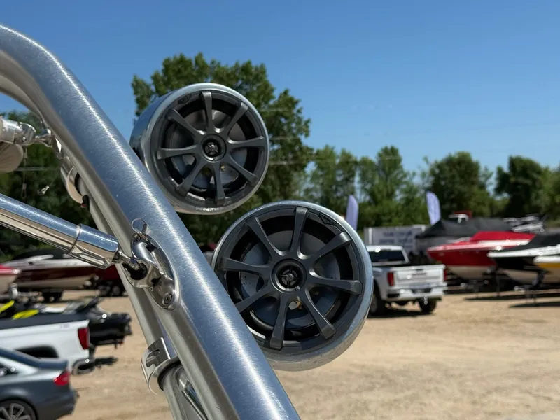 Slide: The Image of Speakers mounted on a 2009 Crownline 270 BR boat, with other boats in the background. - 12