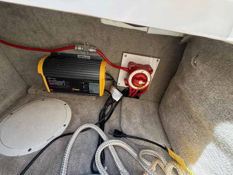 Slide: The Image of Battery compartment of 2009 Crownline 270 BR with ProMariner ProSport12 charger and red power switch. - 14