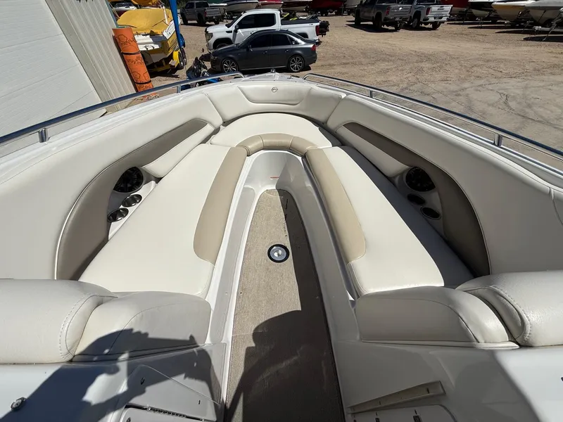 Slide: The Image of 2009 Crownline 270 BR boat interior with beige seating and cup holders. - 17