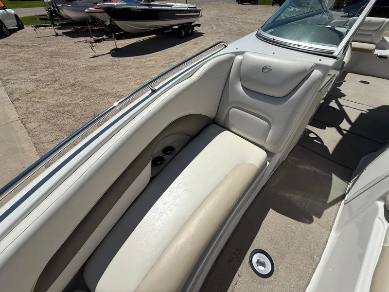 Slide: The Image of 2009 Crownline 270 BR boat interior with beige seating and cup holders. - 19