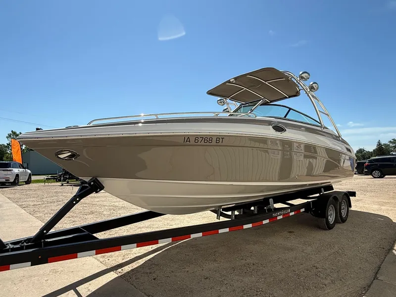 Slide: The Image of 2009 Crownline 270 BR boat on trailer under clear blue sky. - 2