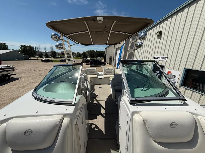 Slide: The Image of 2009 Crownline 270 BR boat with canopy, parked outdoors near a building. - 20