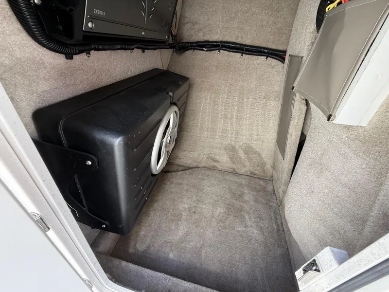 Slide: The Image of 2009 Crownline 270 BR interior storage compartment with speaker and wiring. - 21