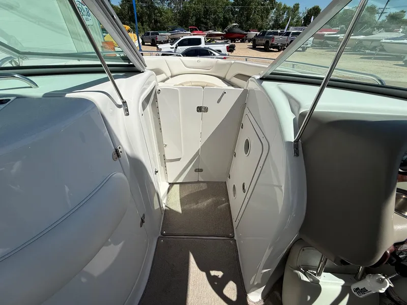 Slide: The Image of 2009 Crownline 270 BR boat interior with open cabin door and seating area. - 22