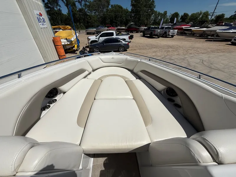 Slide: The Image of 2009 Crownline 270 BR boat interior with white leather seating and cup holders. - 24