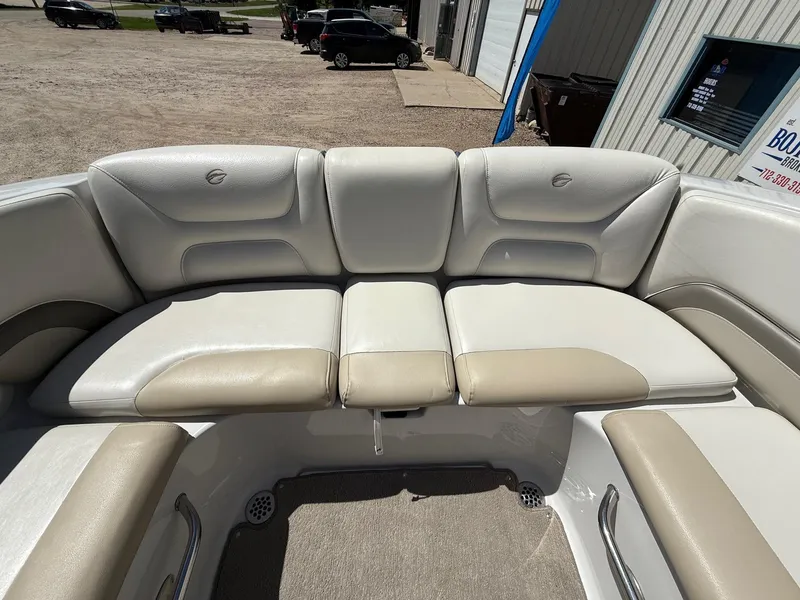 Slide: The Image of 2009 Crownline 270 BR boat interior seating with beige and white upholstery. - 27