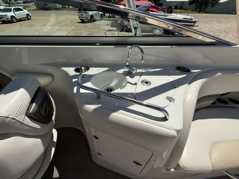 Slide: The Image of 2009 Crownline 270 BR boat interior with sink and seating area. - 29