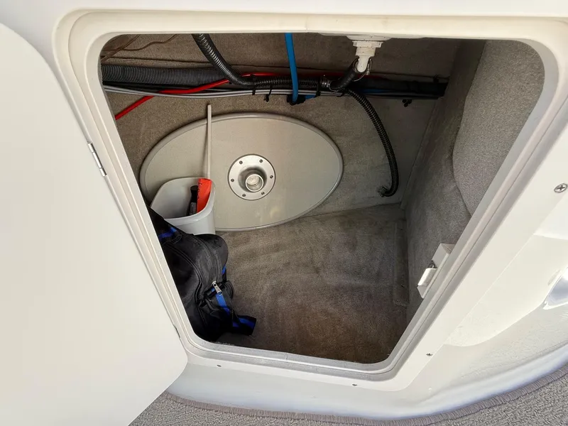 Slide: The Image of Storage compartment of 2009 Crownline 270 BR boat with equipment and wiring. - 30