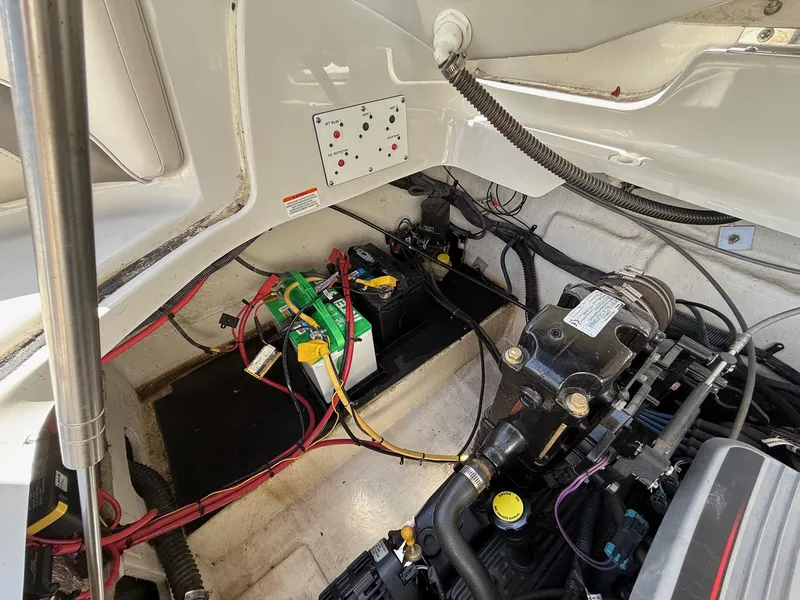Slide: The Image of Engine compartment of a 2009 Crownline 270 BR boat, showing battery and wiring. - 32
