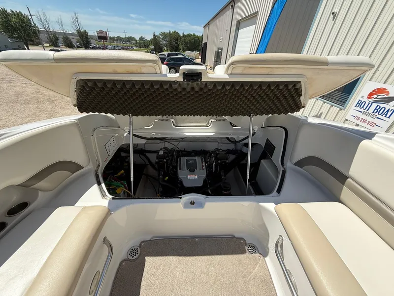 Slide: The Image of 2009 Crownline 270 BR boat engine compartment with open hatch, showcasing interior components. - 35