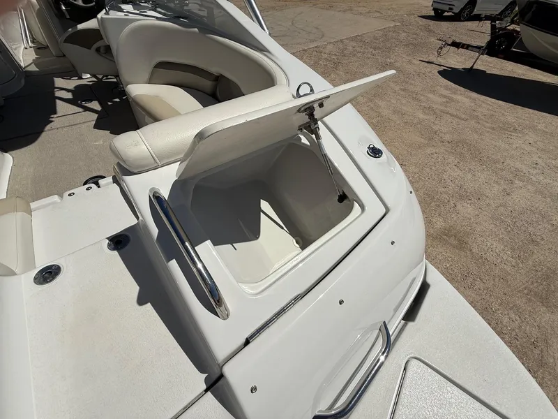 Slide: The Image of 2009 Crownline 270 BR boat interior with open storage compartment and seating. - 36