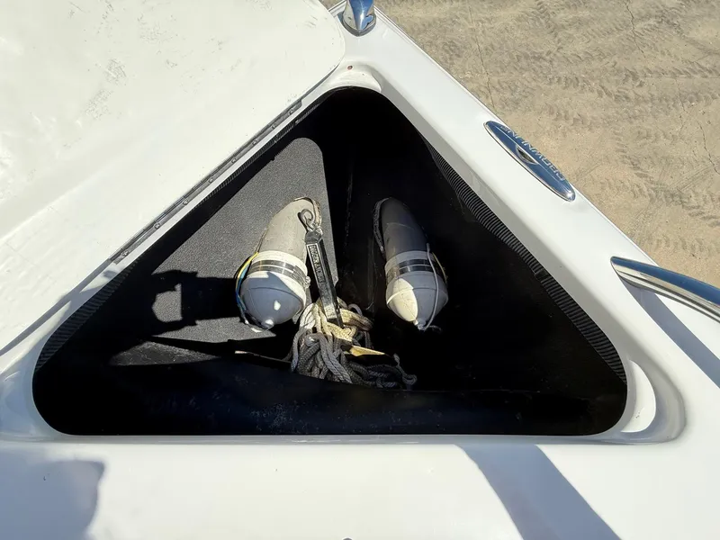 Slide: The Image of Storage compartment on a 2009 Crownline 270 BR boat with fenders and ropes. - 4