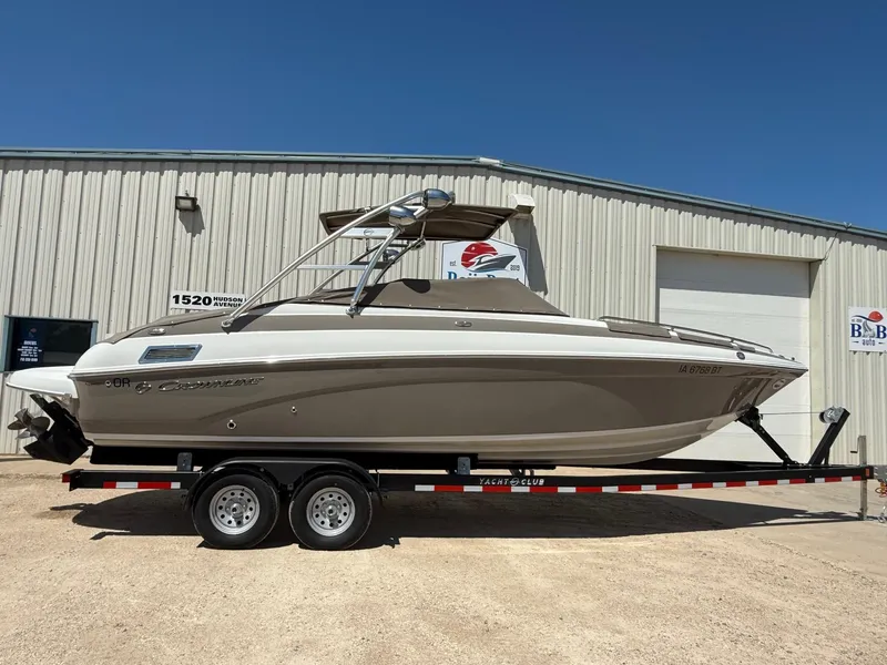Slide: The Image of 2009 Crownline 270 BR boat on trailer, parked outside a warehouse. - 40