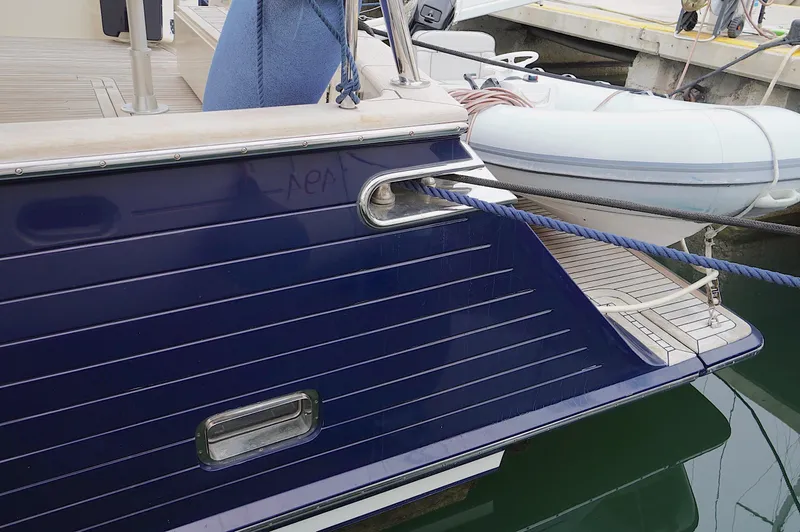 Slide: The Image of Stern view of 2009 Marlow 61E yacht docked with tender boat. - 11