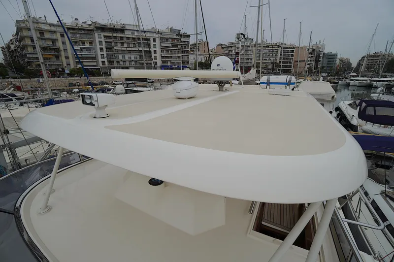 Slide: The Image of Marlow 61E yacht roof view in marina, surrounded by other boats and cityscape, 2009 model. - 12