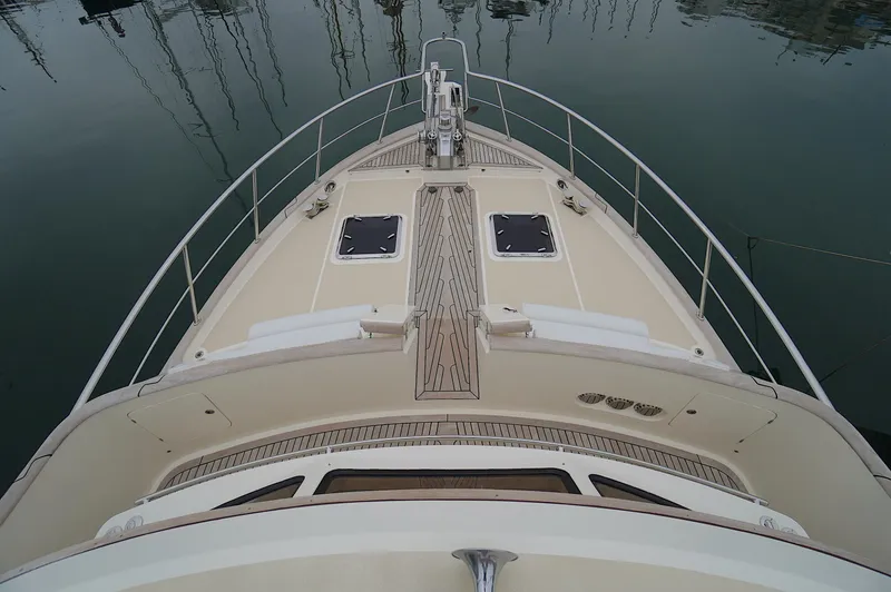 Slide: The Image of Bow view of 2009 Marlow 61E yacht with teak deck and railings. - 13