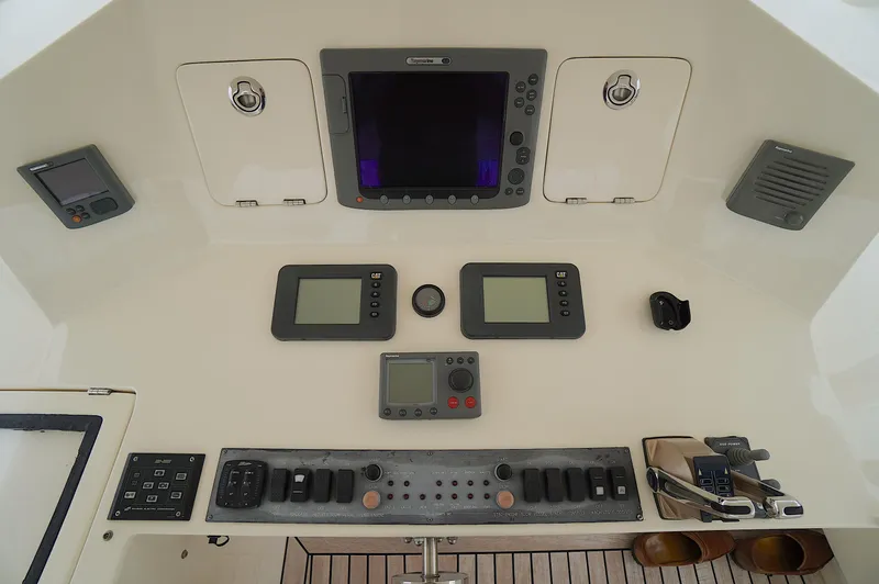 Slide: The Image of Control panel of a 2009 Marlow 61E yacht with navigation and communication equipment. - 14
