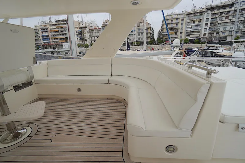Slide: The Image of Luxurious seating area on a 2009 Marlow 61E yacht, docked in a marina. - 18