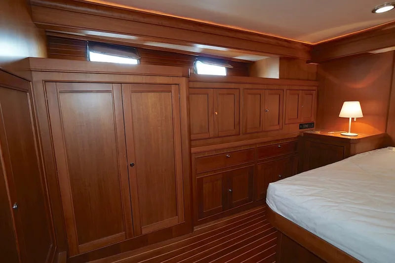 Slide: The Image of Luxurious wooden cabin interior of 2009 Marlow 61E yacht with bed and lamp. - 21
