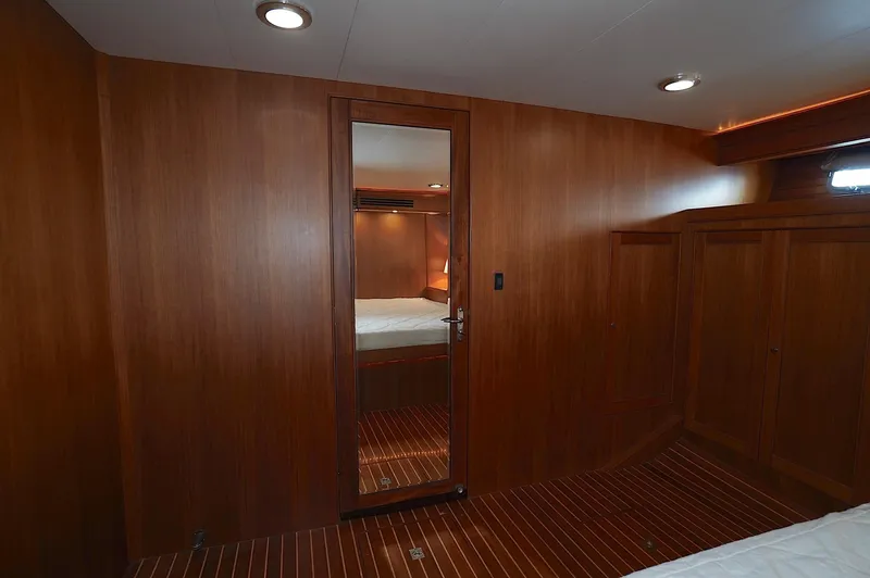 Slide: The Image of Luxurious wooden interior of 2009 Marlow 61E yacht cabin with mirror and ambient lighting. - 23