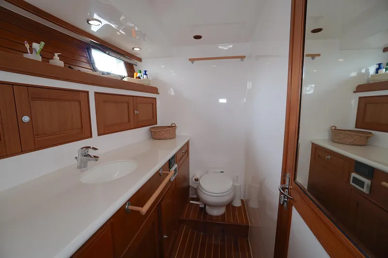 Slide: The Image of Luxurious Marlow 61E 2009 yacht bathroom with wooden cabinets and modern fixtures. - 24