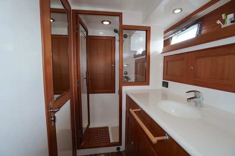 Slide: The Image of Luxurious Marlow 61E 2009 yacht bathroom with wooden cabinetry and modern fixtures. - 25