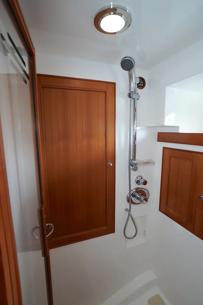 Slide: The Image of Shower area in 2009 Marlow 61E yacht with wooden accents and modern fixtures. - 26