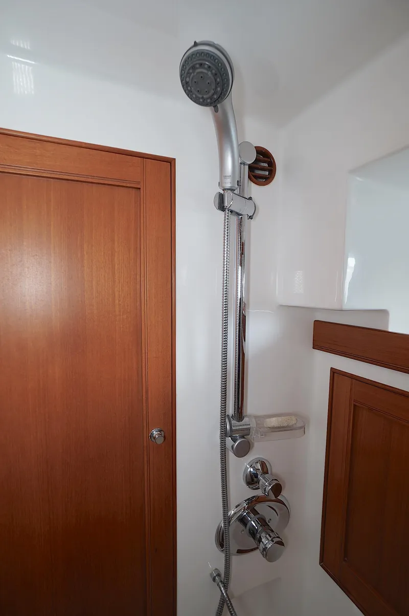 Slide: The Image of Shower area in 2009 Marlow 61E yacht with wooden accents and chrome fixtures. - 27