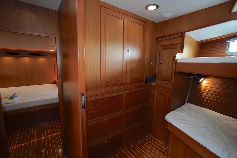 Slide: The Image of Luxurious wooden interior of 2009 Marlow 61E yacht with cozy bunk beds. - 29