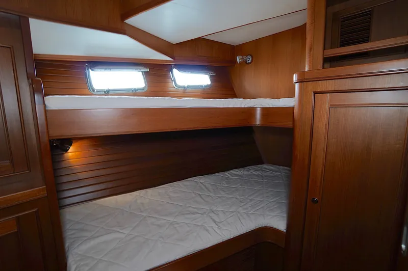 Slide: The Image of Wooden bunk beds in a 2009 Marlow 61E yacht cabin. - 30