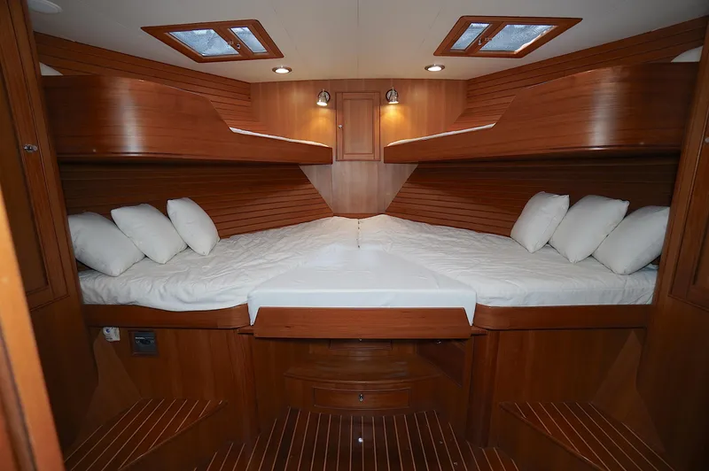 Slide: The Image of Luxurious cabin interior of 2009 Marlow 61E yacht with wooden finish and cozy bedding. - 31