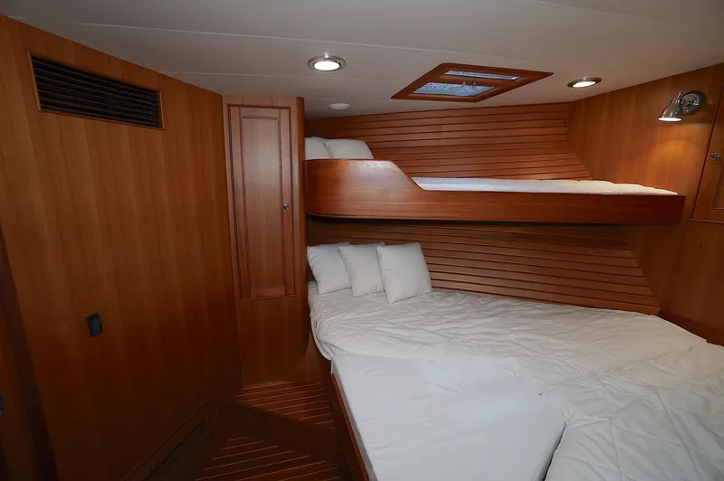 Slide: The Image of Luxurious cabin interior of 2009 Marlow 61E yacht with wooden finishes and cozy bedding. - 32