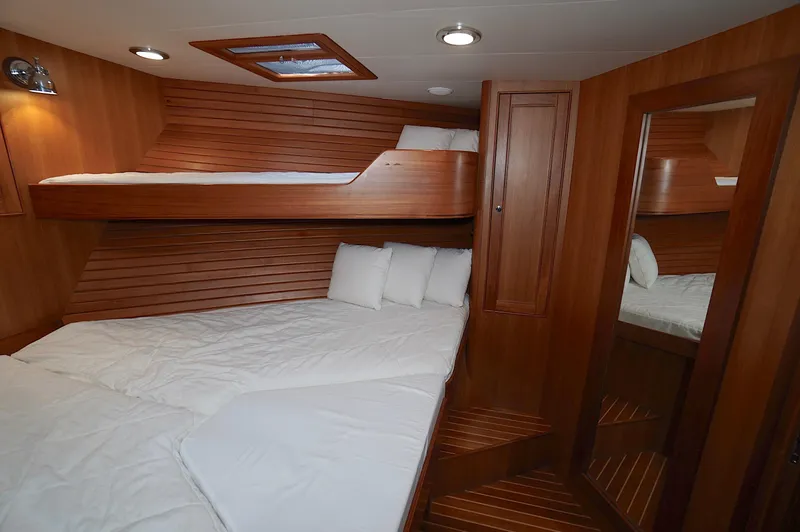 Slide: The Image of Luxurious wooden cabin interior of 2009 Marlow 61E yacht with cozy bunk beds. - 33