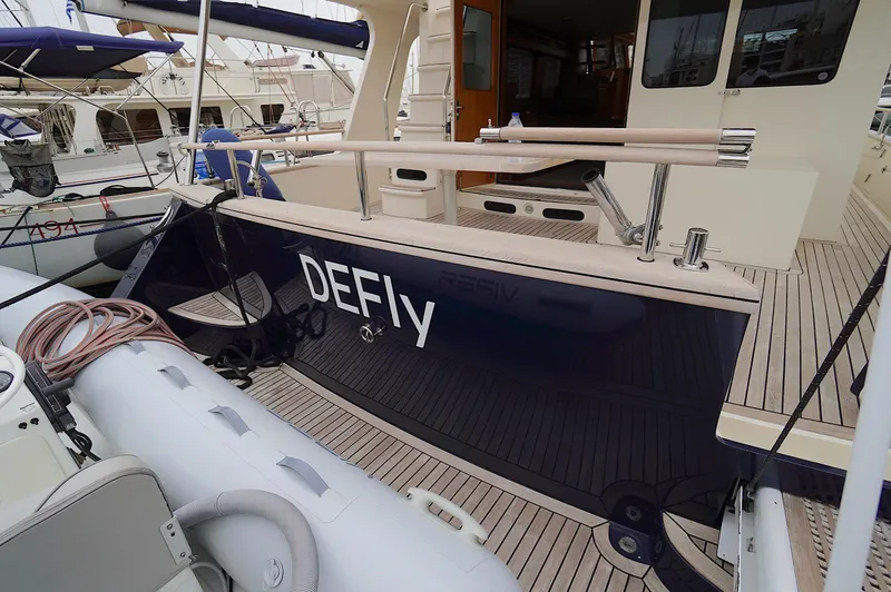 Slide: The Image of 2009 Marlow 61E yacht deck with inflatable boat and wooden flooring. - 4
