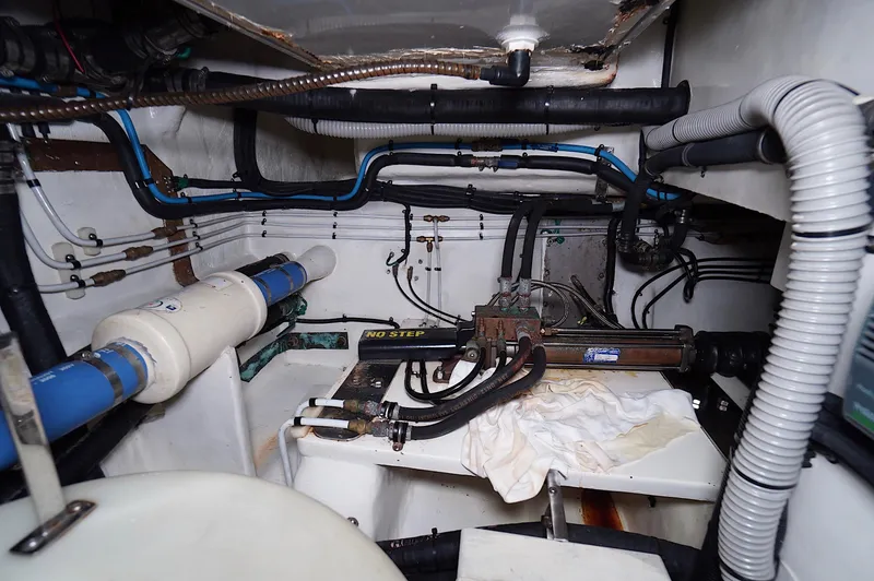 Slide: The Image of Engine room of a 2009 Marlow 61E yacht, featuring pipes and mechanical components. - 42