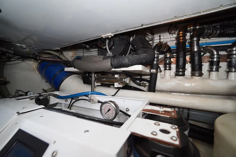 Slide: The Image of Engine room of a 2009 Marlow 61E yacht with pipes and gauges. - 43