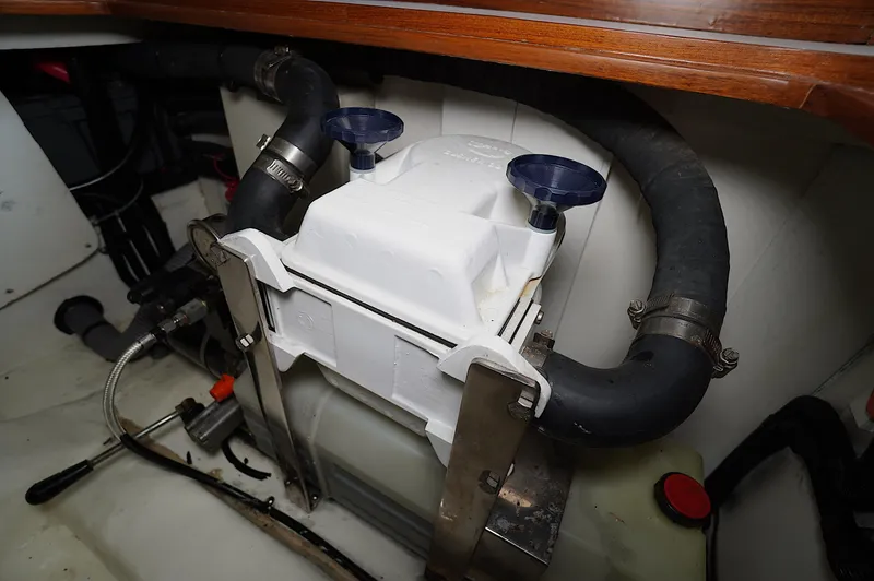 Slide: The Image of Engine compartment of a 2009 Marlow 61E yacht, featuring hoses and mechanical components. - 46