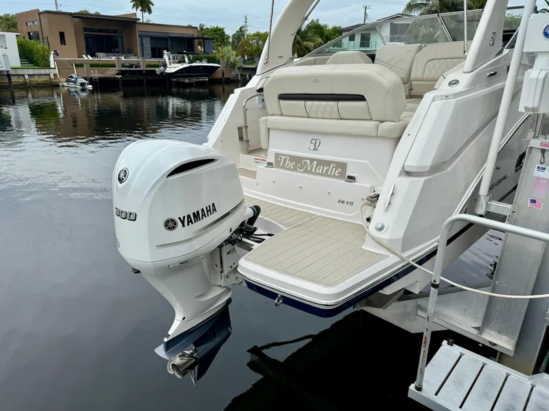 Slide: The Image of 2021 Regal 26 XO boat with Yamaha 300 engine docked by waterfront homes. - 23